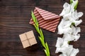 Congratulation. Envelope and box in kraft paper near flower gladiolus on wooden table top view copyspace