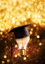 congratulations graduates cap on a lamp bulb with glitter lights