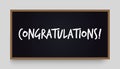 Congratulations lettering on black chalkboard. Graduation, birthday, anniversary greeting congrats handwritten message