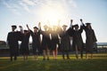 Congratulations are in order. a group of university students standing together on graduation day.