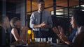 Congratulations team. a diverse group of businesspeople clapping after a successful meeting in the office late at night. Royalty Free Stock Photo