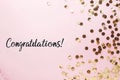 Congratulations text on pastel pink background with gold confetti Royalty Free Stock Photo