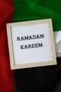 Congratulations with text RAMADAN KAREEM - happy holidays waving UAE flag on background concept. Commemoration Day Royalty Free Stock Photo