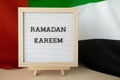 Congratulations with text RAMADAN KAREEM - happy holidays waving UAE flag on background concept. Commemoration Day Royalty Free Stock Photo