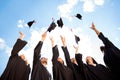 Congratulations to graduates! Low angle shot of cheerful group o