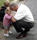 A US congressman plays with a small child who appears happy