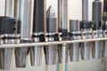 Conical and collet mandrels with cutters and drills on the rack, accessories for the milling machine