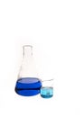 Conical flat flask and Berzelius Beaker filled with colorful blue and teal liquid. Chemistry research and lab Royalty Free Stock Photo