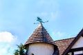 Conical slat roof and winvane Royalty Free Stock Photo