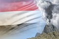 conical volcano blast eruption at day time with white smoke on Yemen flag background, suffer from eruption and volcanic ash