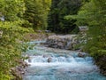 A stormy mountain stream quickly flows down the foam and splashing Royalty Free Stock Photo