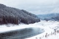 Coniferous forest and mountain lake with snow-covered scenery Royalty Free Stock Photo