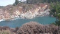 Coniferous pine cypress tree, rock, crag or cliff, ocean beach, California coast Royalty Free Stock Photo