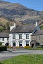 Coniston, United Kingdom - 21st April 2022 : The Crown Hotel Coniston with mountains in the background