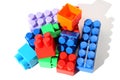 Children`s bright toys in the form of blocks lie in one heap for construction.