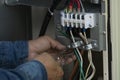 Connect the electrical wiring inside the air conditioner cabinet.