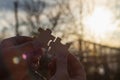 Connect wooden puzzles into a single whole in the evening at sunset as a symbol of unity, friendship, loyalty