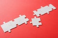Connected jigsaw near puzzle piece on red