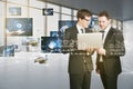 Connecting businesspeople, video conference concept. Attractive european businessmen using laptop with polygonal mesh and images