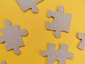 connecting couple puzzle piece, wood jigsaw on yellow background. Business solutions, mission, success, goals and strategy