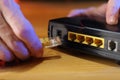 Connecting internet cable to old adsl modem Royalty Free Stock Photo
