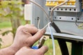 Connecting power cable to an outdoor electrical switchboard or distribution board.