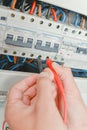 Connecting probes multimeter to fusebox Royalty Free Stock Photo