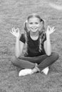 Connecting to your higher self. Happy child keep hands in mudra. Little girl meditate on green grass. Mudra of