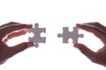 Connection concept : Hands holding pieces of jigsaw puzzle on white Royalty Free Stock Photo