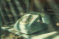 Connection concept. Old green telephone on table with ray light. Royalty Free Stock Photo