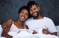 The connection we have is never going away. a young couple using a digital tablet and having coffee in bed at home. Royalty Free Stock Photo