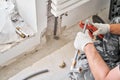 Plumber cuts the desired length of pipe with scissors tool. connection heating pipes to white Radiator in a new Royalty Free Stock Photo