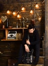 Connection through music. Man bearded musician enjoy evening with bass guitar, wooden background. Man with beard holds Royalty Free Stock Photo