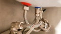 Connection of water supply, hot and cold water to the boiler. Hose for hot and cold water in the bathroom. Plumbing Royalty Free Stock Photo