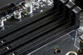 Connectors for installing DDR5 RAM on a black motherboard of a modern computer. Photo. Selective focus Royalty Free Stock Photo