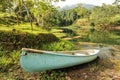 Conoe boat sits next to tropical pond Royalty Free Stock Photo