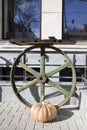 The conposition of the old wheel and ripe pumpkin