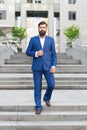 Conquer business world. Office worker confidently step on stairs. Bearded man going to work. Business man in modern city Royalty Free Stock Photo