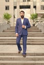 Conquer business world. Office worker confidently step on stairs. Bearded man going to work. Business man in modern city Royalty Free Stock Photo