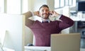 Conquer your goals and be happy. a businessman talking on his cellphone while sitting at his desk.