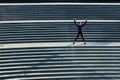 Conquering her fitness goals. High angle shot of an attractive young sportswoman doing jumping jacks on outside stairs.