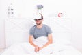 Conscious awakening. Return to reality. Man explore vr while relaxing in bed. VR technology and future. VR communication