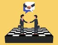 Consensus building and strategic partnership. Businessman firmly shaking hands standing on giant chess board