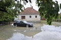 The consequences of flooding, car in front of flooded house. Royalty Free Stock Photo