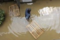 The consequences of flooding, man in the water helping neighborhood.