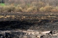 The consequences of a forest fire. The remains of a burnt-out old wooden house in Ukraine. Ashes and burnt things are lying on the Royalty Free Stock Photo