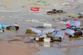 Consequences of sea water pollution on the beach after the full moon party. Island Koh Phangan, Thailand