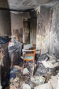 Consequences after a short circuit, burnt house interior, damaged apartment after fire, burned room, charred furniture, household Royalty Free Stock Photo