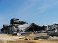 Consequences of a warehouse fire. The metal structure building collapsed from the fire, the columns and walls were burnt