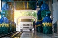 Conservative automatic carwash machine with sunlight effect, van driving through automated car wash machine, car washing with foam Royalty Free Stock Photo